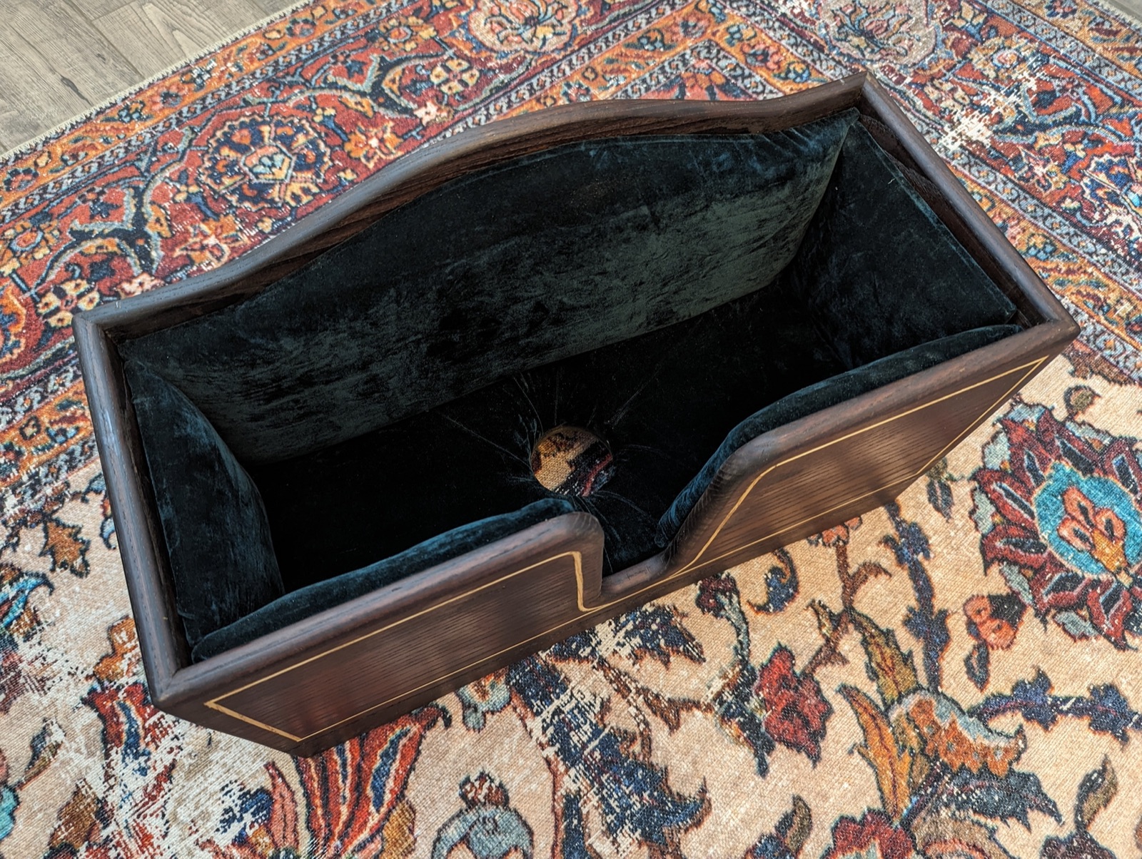 Forest green felt upholstery lining the interior of the cello box