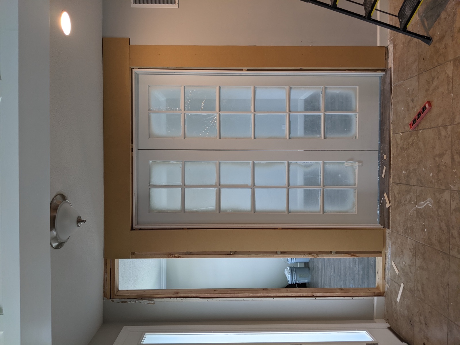 Columns and header at the French door being installed