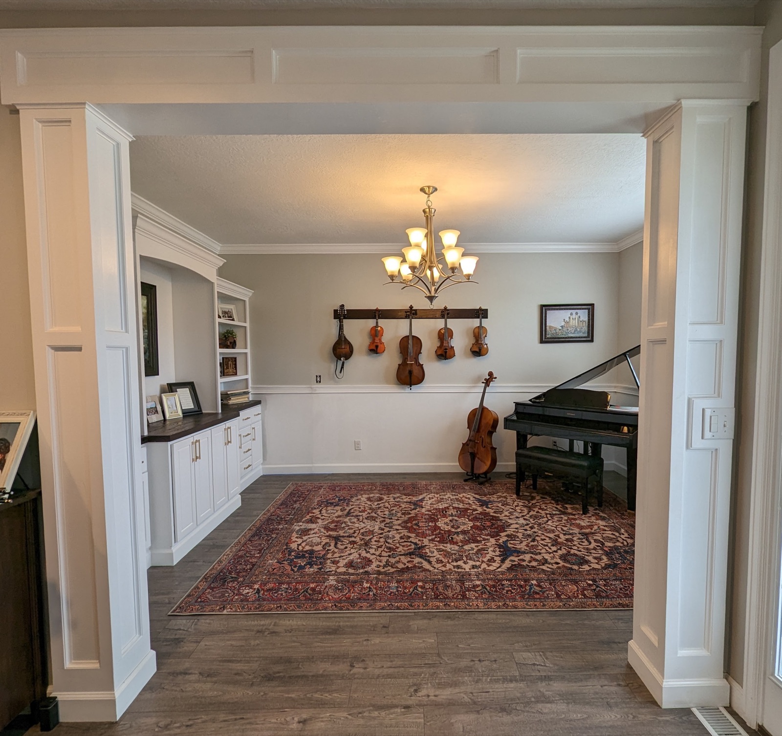 Finished columns and header trim around a music room opening